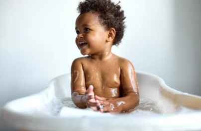 Boy taking bubble bath.