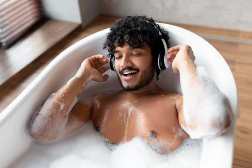 Man listening to music in bath tub